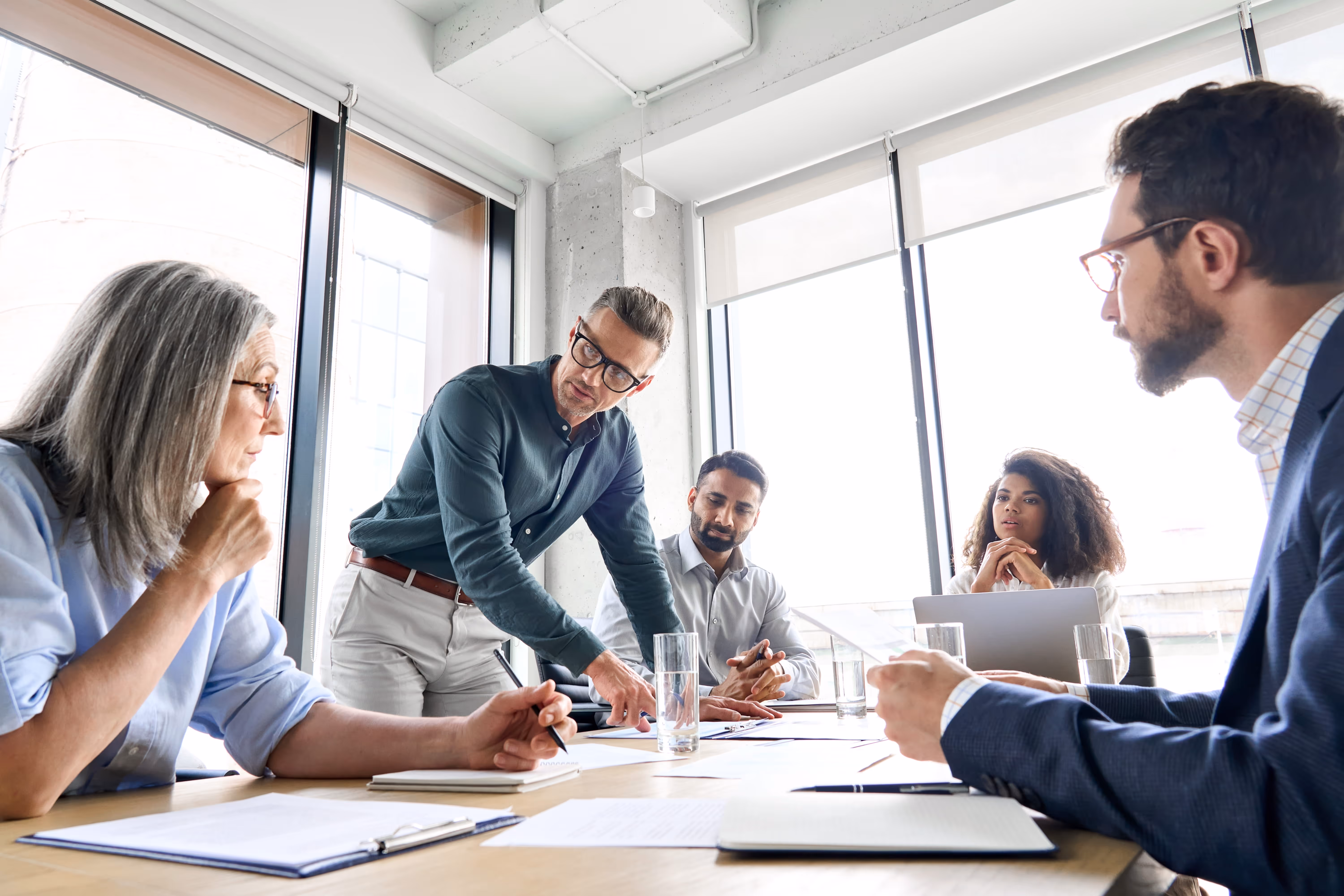 A group of workers have a meeting In a boardroom
