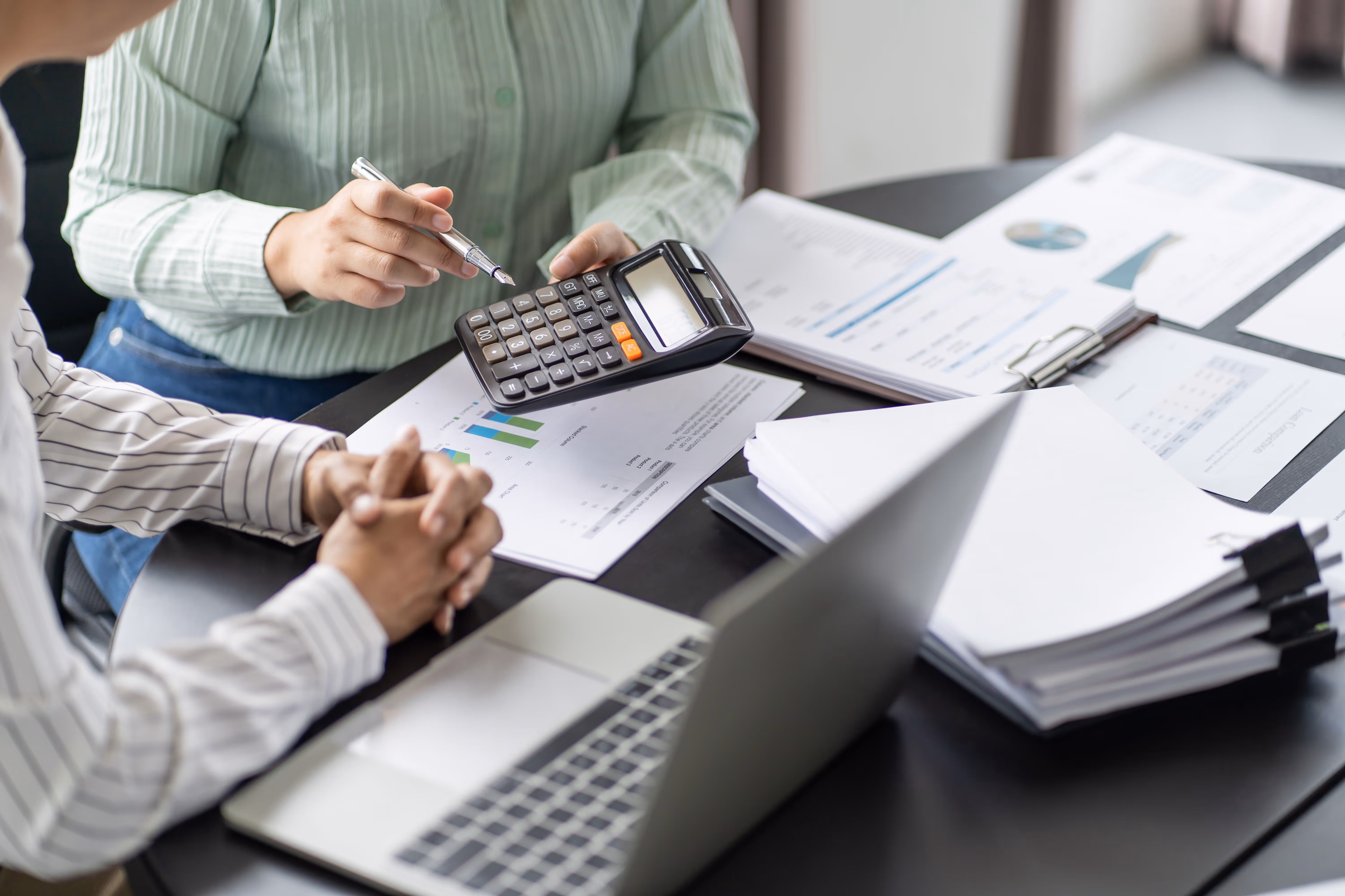 Two staff working together on their desk